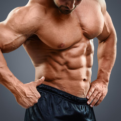Fototapeta na wymiar Man with torso muscles showing ok sign.