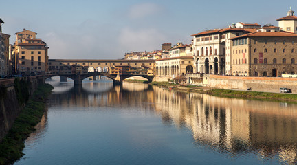 Medieval bridge with shops over the Arno river. On the right side is Uffizi Gallery, one of the most popular tourist attractions of Florence and Museo Galilei.
