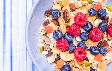 Healthy breakfast top view with text space.Bowl with cereals and berries.