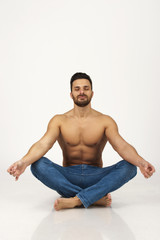 Man in jeans on white, isolated,practicing yoga,calmness,meditat