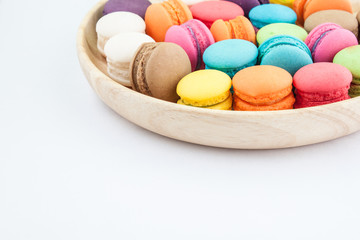 macarons colorfull in wooden bowls on white background