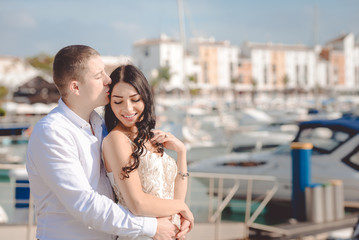 Happy loving couple on sunny marina outdoors background