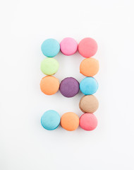 Fototapeta na wymiar colorful macarons arrangment is number nine