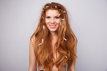 red-haired girl with clothespins in her hair