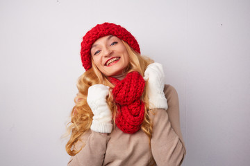 blonde in a red hat and scarf smiling