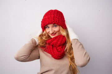 blonde in a red hat and scarf smiling