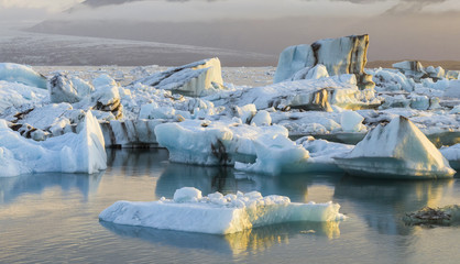 old icebergs and sun lights reflections on the ice in lagoon in Iceland
