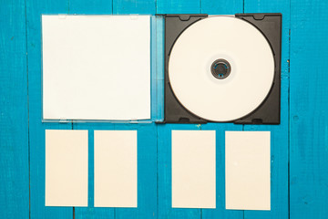 DVD ROM and business cards on a wooden background. Mock-up for b
