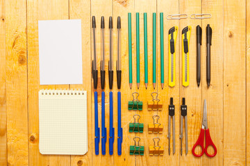 stationery items arranged on a wooden background
