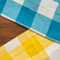 Two checkered towels on wooden background