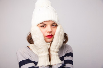 girl in white hat and scarf is frozen