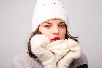 girl in white hat and scarf is frozen