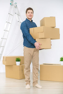 Pleasant man holding boxes 