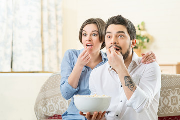 Vivacious couple watching TV 