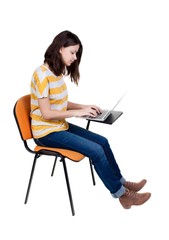 Side view of  woman sitting on a chair to study with a laptop.
