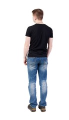 Back view of man in jeans. Standing young guy.