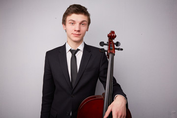 young man with a cello © photoniko