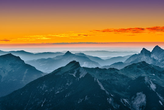 view over blue mountains with golden yellow sunset sky