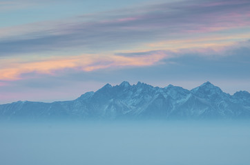 Fototapeta na wymiar Tatra Mountains from Gorc in Beskidy mountains, winter evening