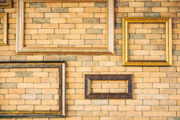 Fototapeta na wymiar Blank photo frame on brick wall