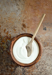 Homemade yogurt or a sour cream in a rustic bowl