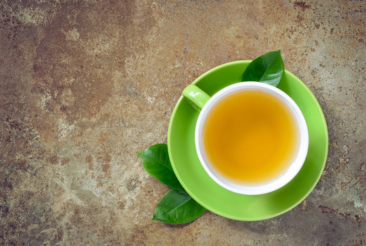 Cup of fresh green tea, overhead view, concept background