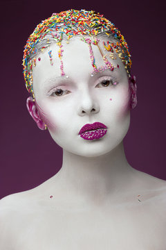 Fashion model with creative make-up girl in sweets