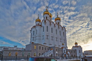 Fototapeta na wymiar Piously-Troitsk cathedral on a decline in clouds. Magadan. Winter. Kolyma IMG_7576