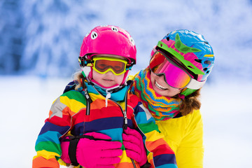 Mother and little girl learning to ski