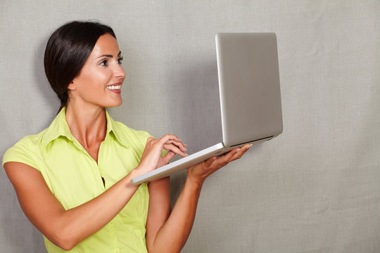 Adult Lady Standing While Using Laptop