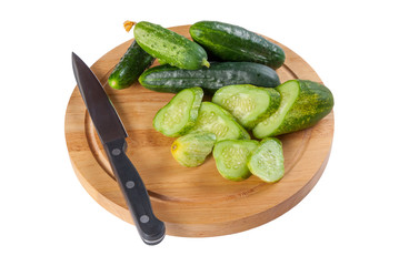 Whole and sliced green cucumbers