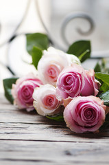 Pink roses on the wooden table