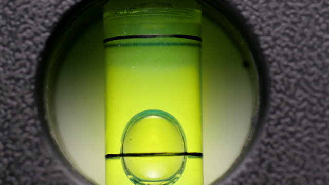 Carpenter's spirit level close up. Measuring the flatness with a spirit level.