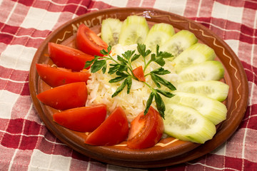 Tomato and cucumber salad on the plate