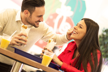 Couple eating in fast food restaurant