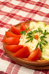 Tomato and cucumber salad on the plate