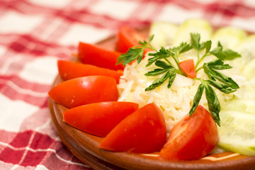 Tomato and cucumber salad on the plate