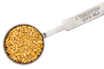 golden flax seed on measuring spoon