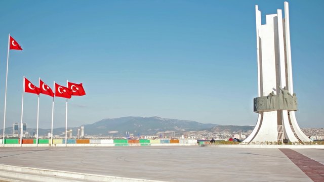 Ataturk statue and Turkish flags waving at Izmir Karsiyaka