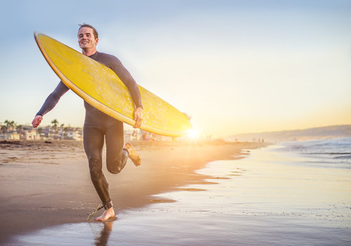 Surfer running on the beach
