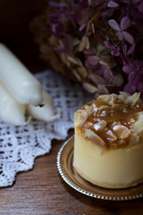 tasty caramel cheesecake / tasty caramel cheesecake and candles on wooden table