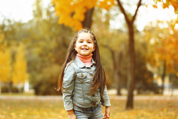 Cute girl playing with soap bubbles in park