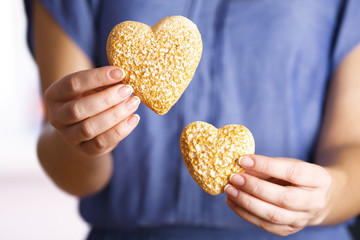 Closeup of craft hearts in female hands