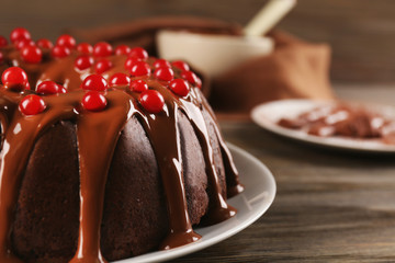 Chocolate cake with snowball tree berries on a table