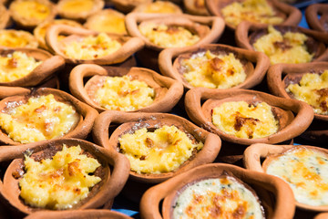 Mashed Potatoes with cheese in a clay pot.