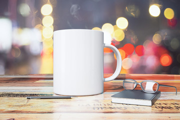 Blank cup of coffee with diary, eyeglasses and pen on wooden tab