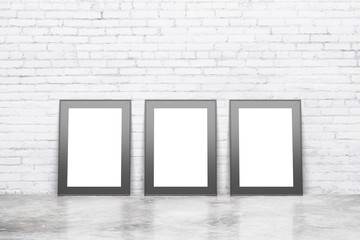Blank white pictures with black frame on concrete floor with whi
