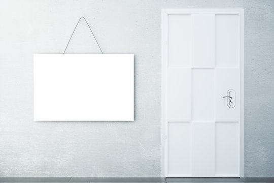 Blank white picture on concrete wall with white door in empty ro