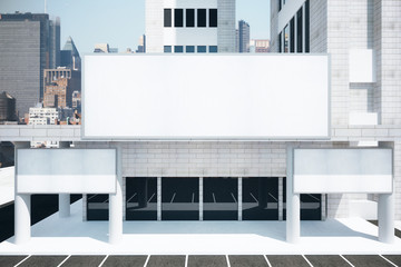 Obraz premium Blank white billboards in financial district of megapolis city a