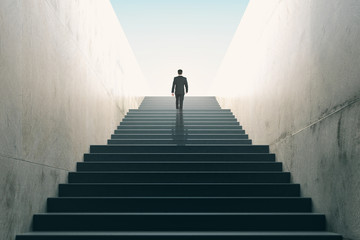 Ambitions concept with businessman climbing stairs - Powered by Adobe